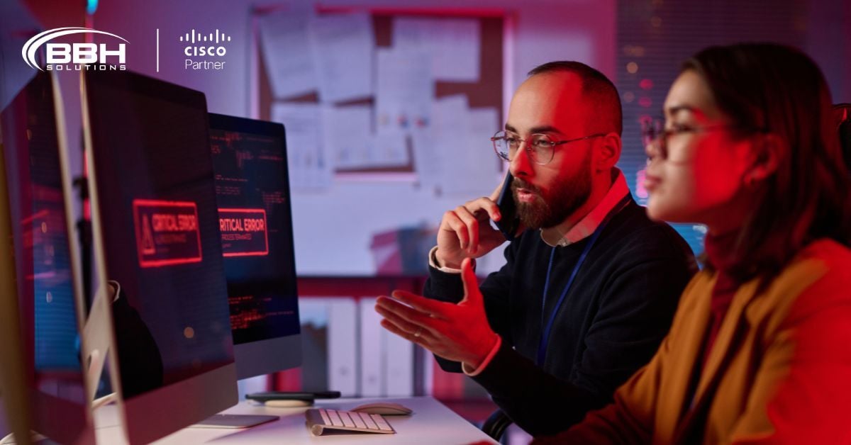 Portrait of agitated cybersecurity team working in emergency mode with critical error message on computer screen